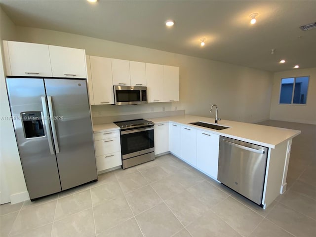 10250 NW 66th St Unit 103, Doral, FL 33178 - kitchen featuring a sink, light countertops, stainless steel appliances, white cabinetry, and a peninsula