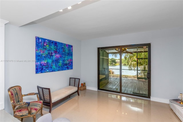 8956 Palm Tree Ln Unit 8956, Pembroke Pines, FL 33024 - living area with a water view, tile patterned floors, and baseboards