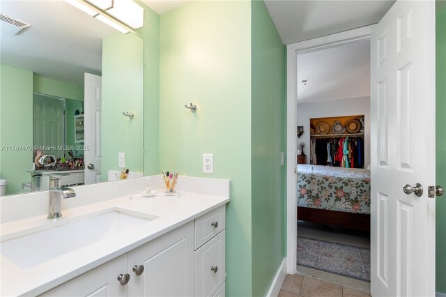 8956 Palm Tree Ln Unit 8956, Pembroke Pines, FL 33024 - ensuite bathroom featuring visible vents, tile patterned flooring, vanity, baseboards, and connected bathroom