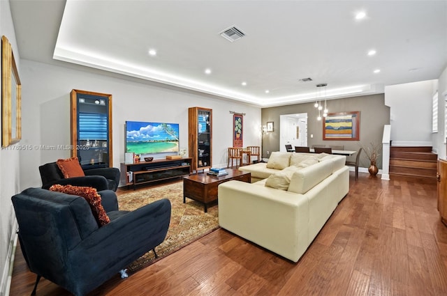 living room featuring visible vents, recessed lighting, stairs, and wood finished floors