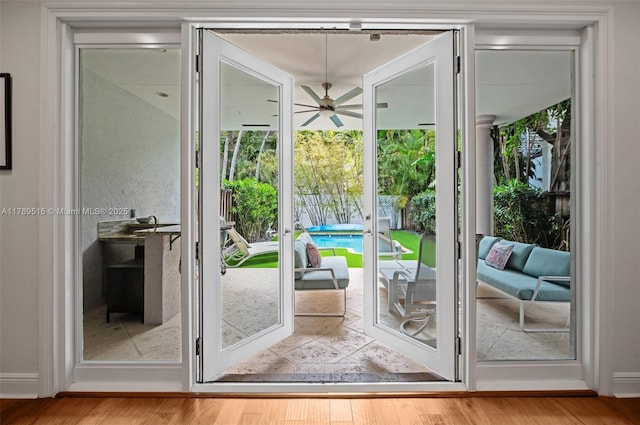 entryway with ceiling fan, french doors, and wood finished floors