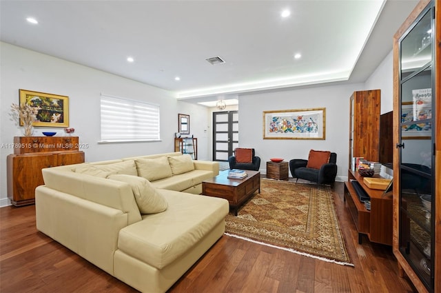 living room featuring recessed lighting, baseboards, dark wood-style flooring, and visible vents