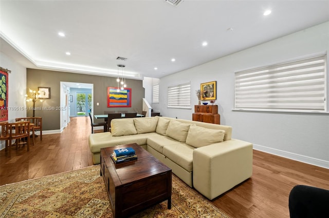 living room with baseboards, recessed lighting, wood finished floors, and visible vents