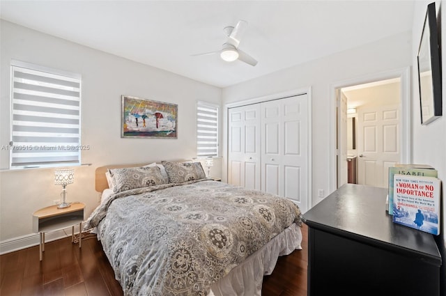 bedroom with baseboards, a ceiling fan, a closet, and dark wood-style floors