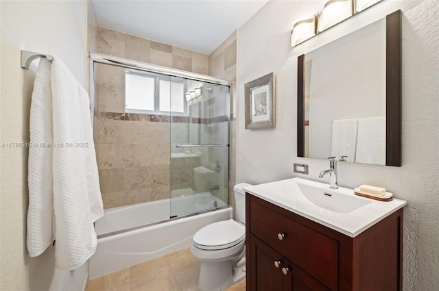 bathroom with vanity, bath / shower combo with glass door, and toilet
