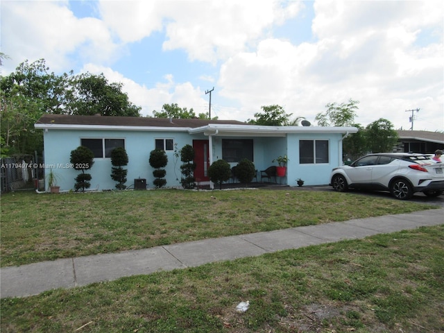 view of front of home with stucco siding and a front yard