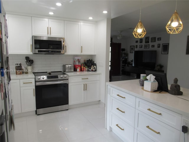 kitchen with white cabinets, stainless steel appliances, and tasteful backsplash