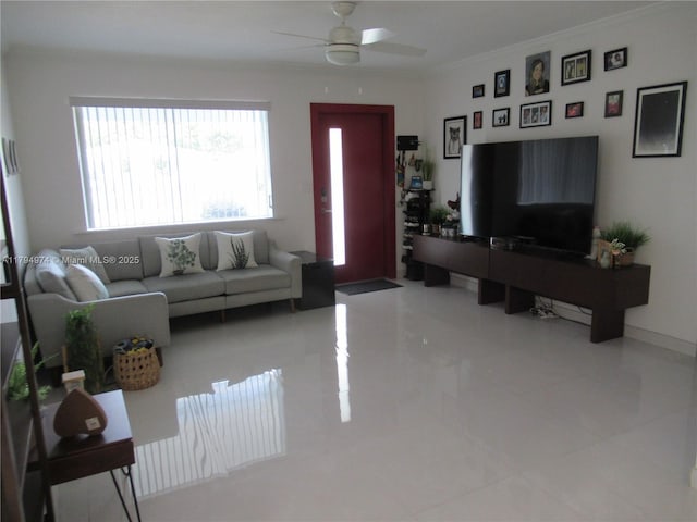 living area with crown molding and a ceiling fan