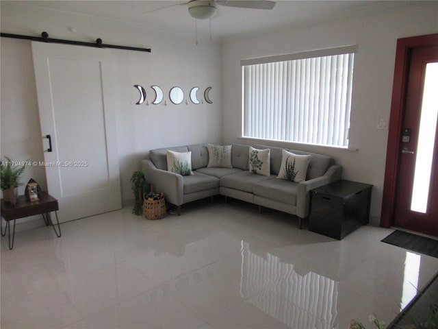 tiled living area with ceiling fan, a barn door, and a wealth of natural light