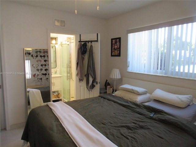 bedroom featuring visible vents and ensuite bath