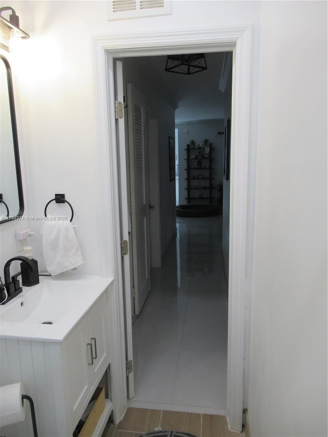 bathroom with visible vents, a sink, and tile patterned flooring