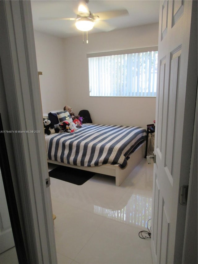 bedroom with tile patterned floors and ceiling fan
