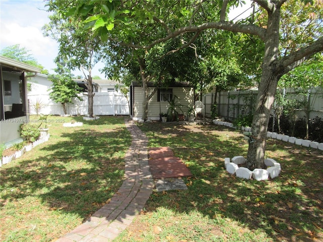 view of yard with an outdoor structure and a fenced backyard