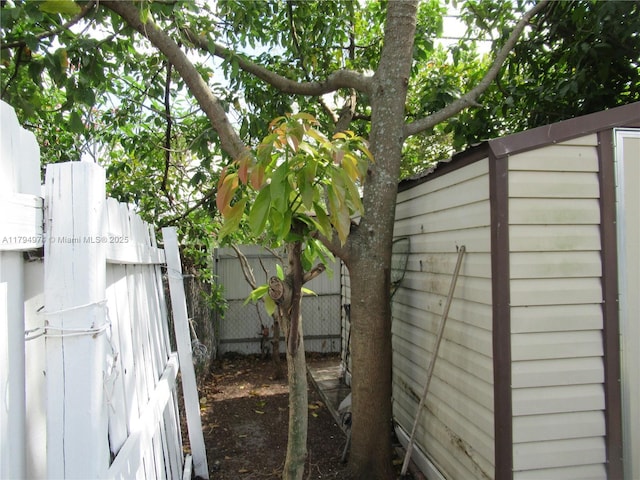 view of side of home featuring fence