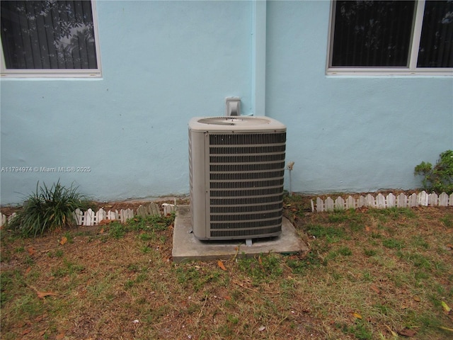 details with central air condition unit and stucco siding