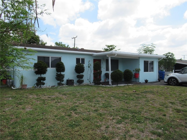 view of front of home with stucco siding and a front yard