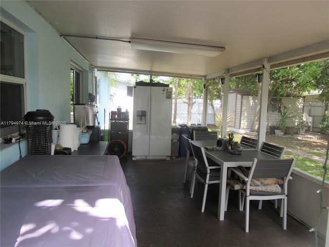 sunroom featuring plenty of natural light and outdoor dining space
