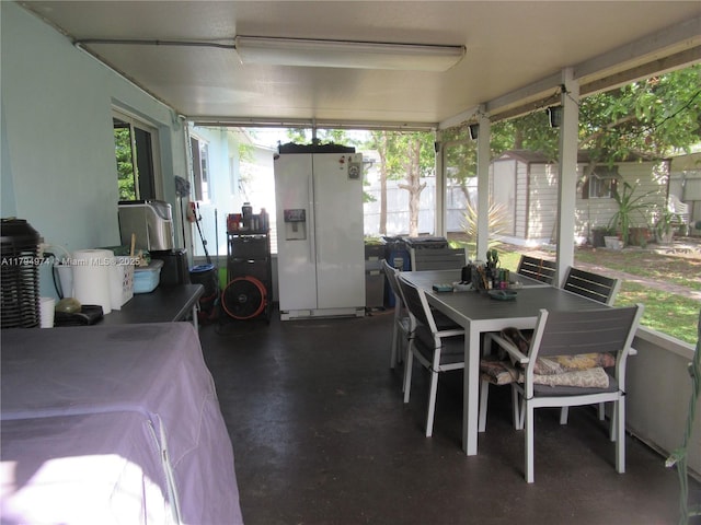 sunroom / solarium featuring outdoor dining area