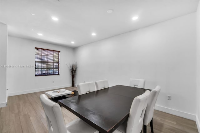 dining room featuring light wood finished floors, baseboards, and recessed lighting