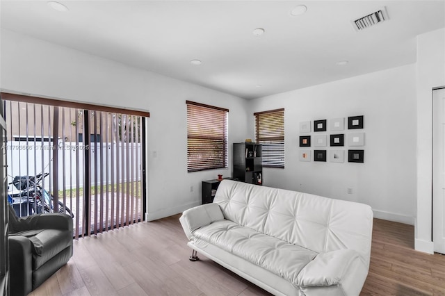 living room with baseboards, recessed lighting, visible vents, and wood finished floors