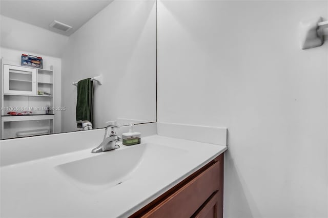 bathroom with vanity and visible vents
