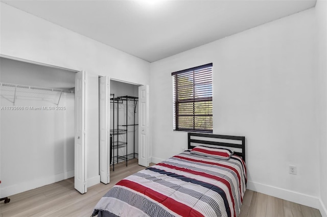 bedroom with baseboards and wood finished floors