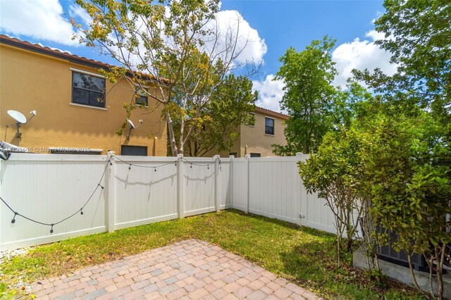 view of yard featuring a patio, a fenced backyard, and a gate
