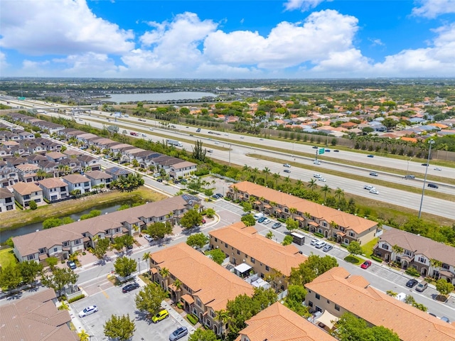 birds eye view of property with a water view and a residential view