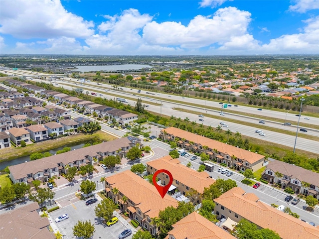 drone / aerial view with a water view and a residential view