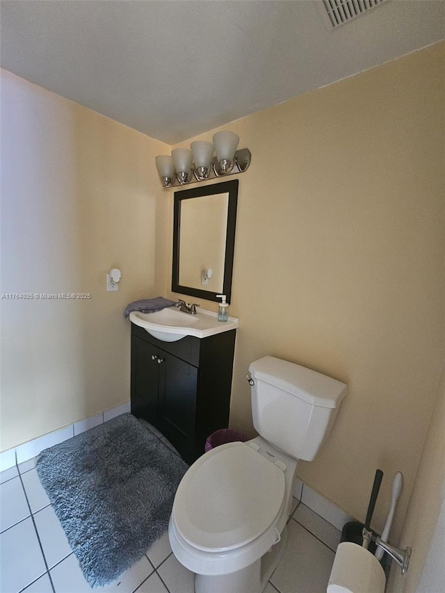 bathroom featuring visible vents, tile patterned floors, toilet, and vanity