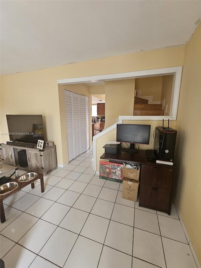 living room with baseboards and light tile patterned floors