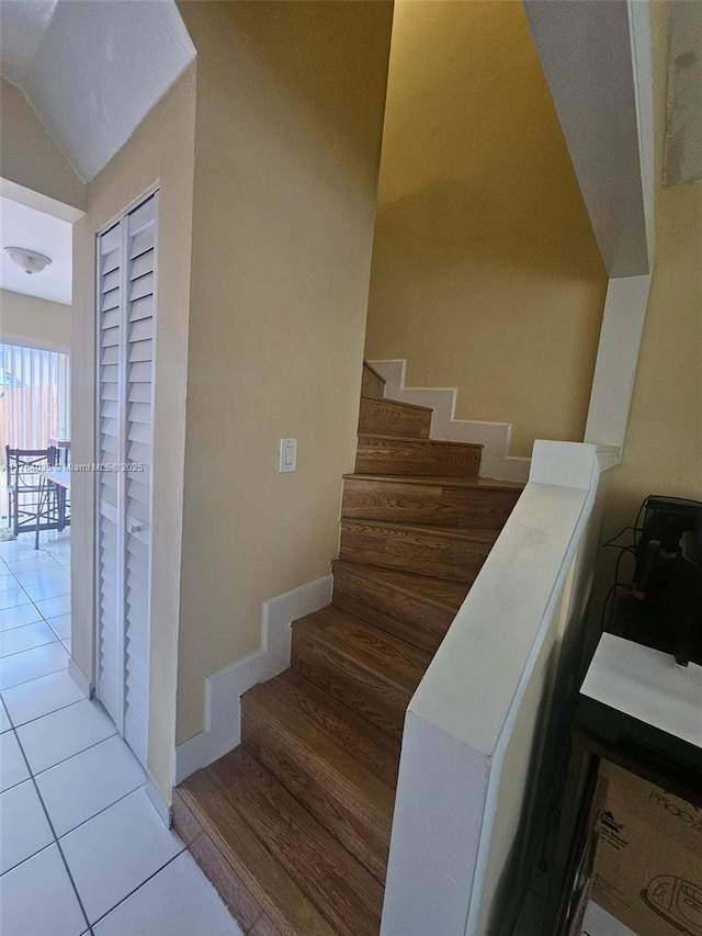 stairway with tile patterned floors