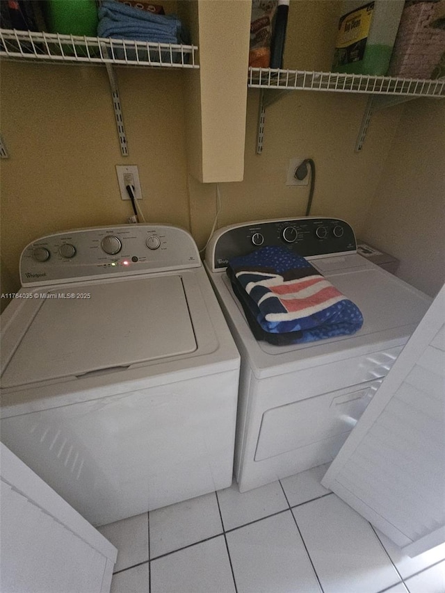 laundry room with washer and dryer, laundry area, and tile patterned flooring