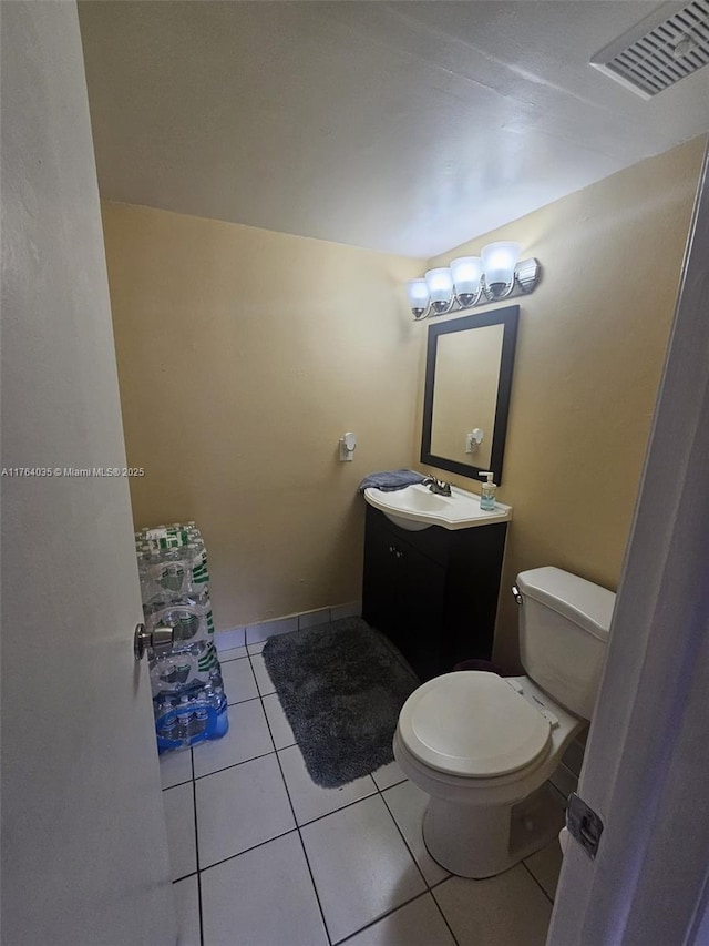 half bath featuring visible vents, tile patterned floors, toilet, and vanity