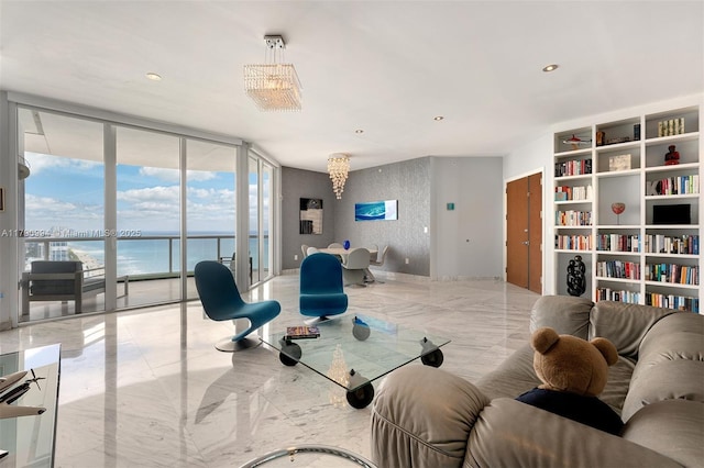 sitting room with a water view, a wall of windows, and marble finish floor
