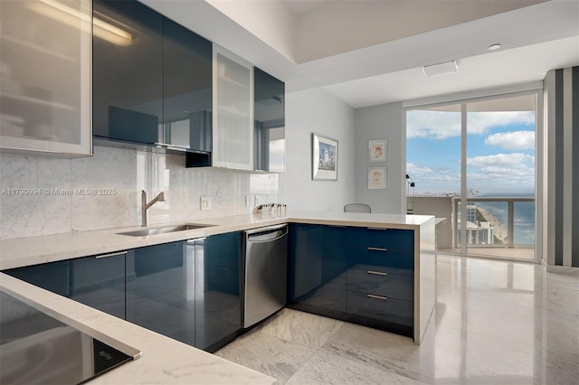 kitchen featuring decorative backsplash, a peninsula, modern cabinets, a sink, and dishwasher