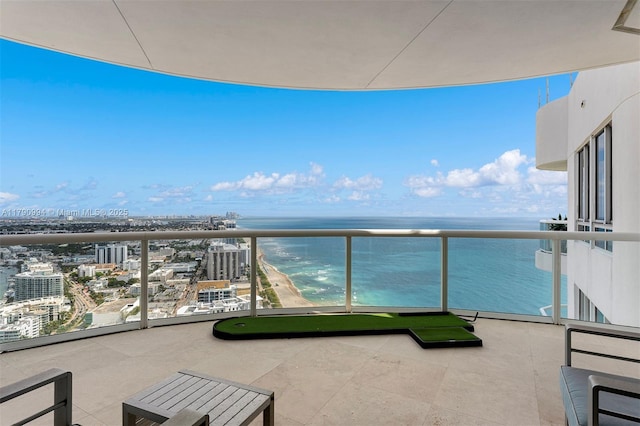 balcony featuring a city view and a water view