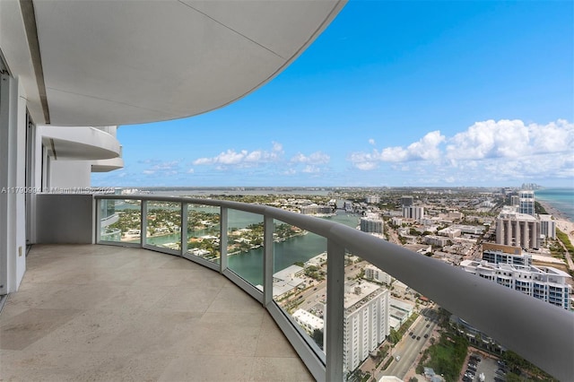 balcony featuring a view of city and a water view