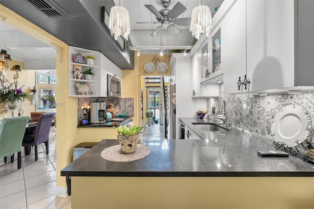 kitchen featuring open shelves, appliances with stainless steel finishes, a sink, a ceiling fan, and tasteful backsplash