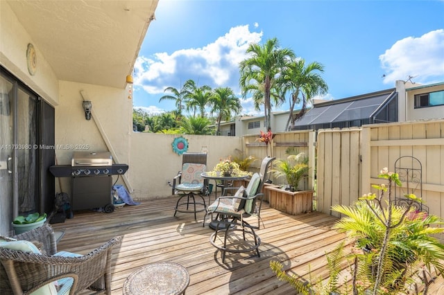 deck featuring a fenced backyard and a grill