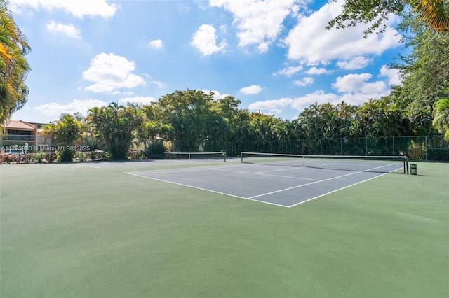 view of sport court featuring fence