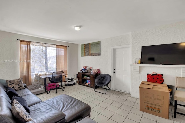 living area with light tile patterned floors and a textured wall