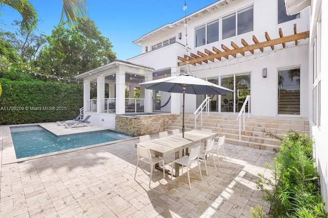 back of property featuring a gazebo, a fenced in pool, a patio area, and stucco siding