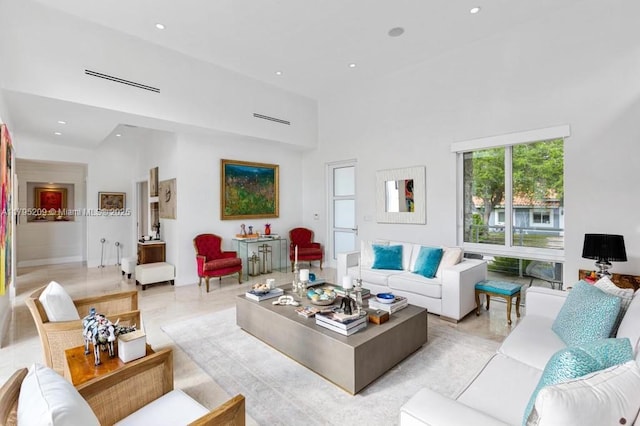 living area featuring recessed lighting and a high ceiling