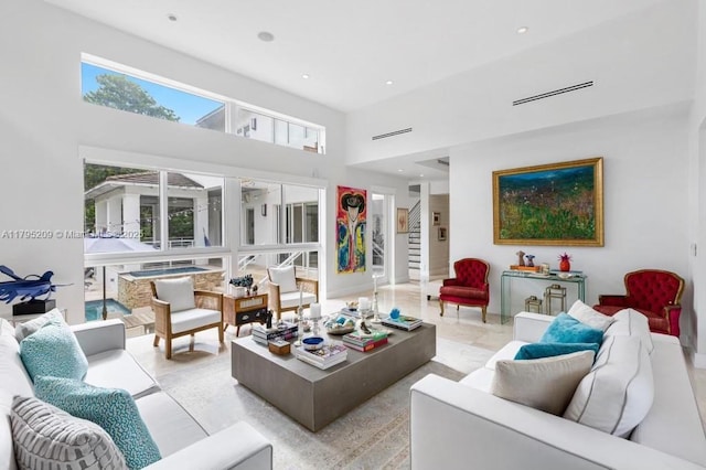 living area featuring recessed lighting and a high ceiling