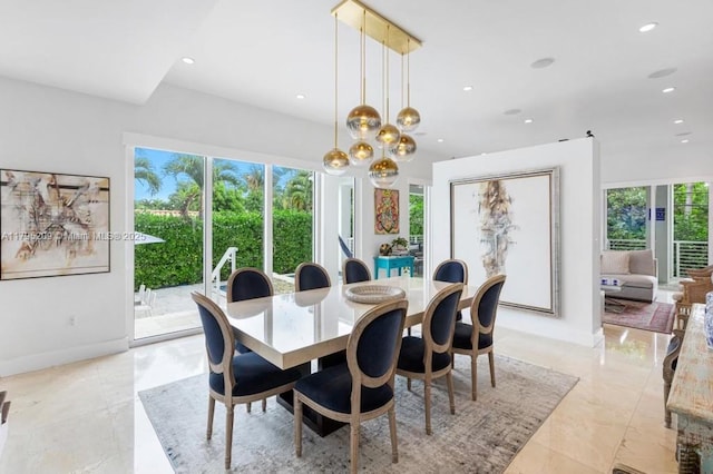 dining space featuring an inviting chandelier, recessed lighting, baseboards, and a healthy amount of sunlight