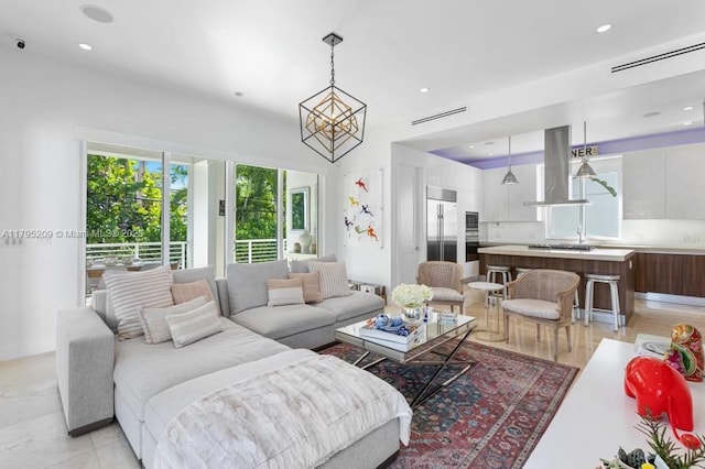 living area featuring visible vents and recessed lighting