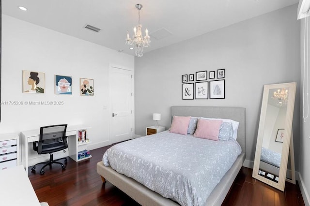 bedroom with an inviting chandelier, recessed lighting, wood finished floors, and visible vents