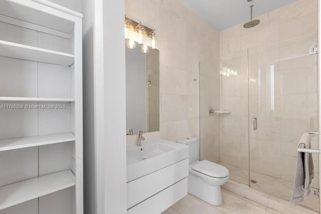 bathroom featuring vanity, tile patterned flooring, a stall shower, and toilet