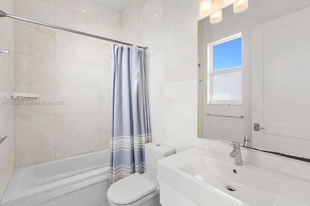 full bathroom featuring a sink, tile walls, shower / bath combo with shower curtain, and toilet
